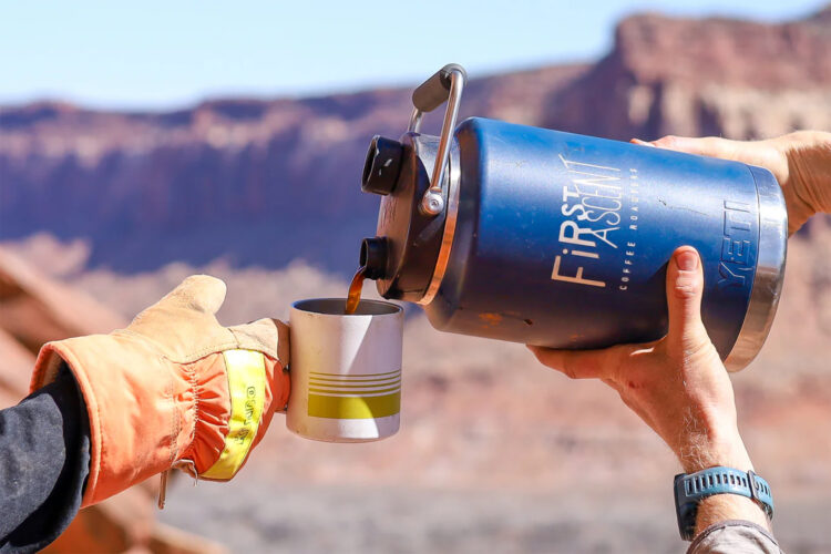 Person pours a cup of First Ascent Coffee.