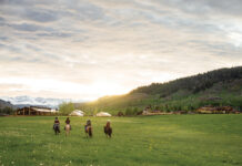 People ride horses at The Home Ranch.