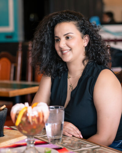 Woman eats at a restaurant in Aurora.