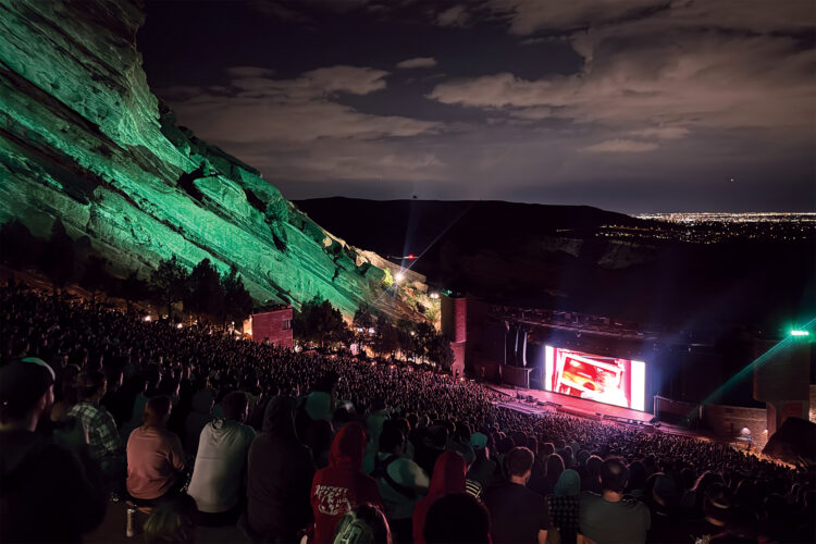 People watch a movie at night at Red Rocks Amphitheater.