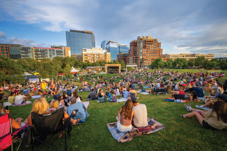 People lounge on the grass at a Denver Park.
