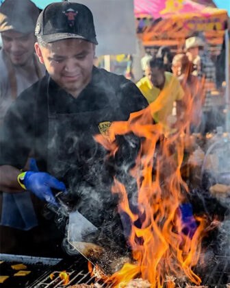 Person grills at Flame Fest.
