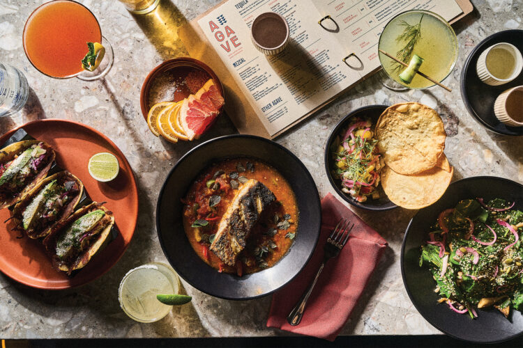 Several dishes on a table at Ash and Agave.