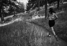 Notace Designs Footwear for Colorado Terrain Woman runs on trail wearing Notace shoes.