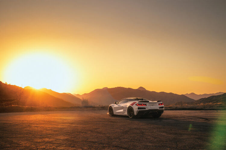 The 2026 Chevrolet Corvette parked in front of the mountains at sunset.