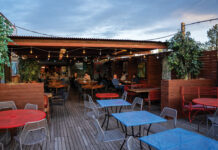 Outside patio and bar area with string light at Joy Hill Denver.