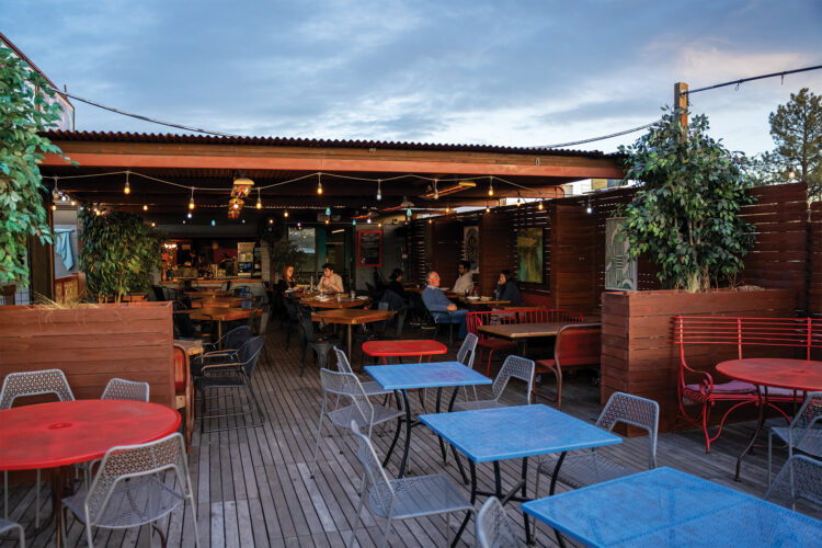 Outside patio and bar area with string light at Recess Beer Garden.