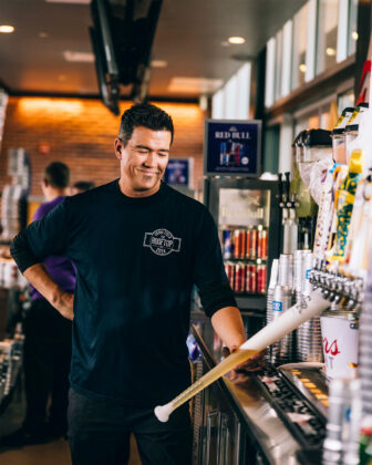 Bartender fills "beer bat" drinks at Coors Field.