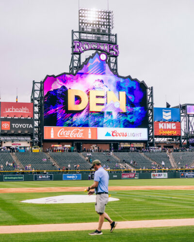 Grounds crew walk across field at Coors Field.