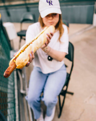 Woman eats the Glizzilla at Coors Field.