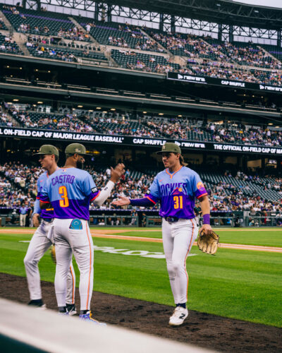 Players high five in city connect jerseys.