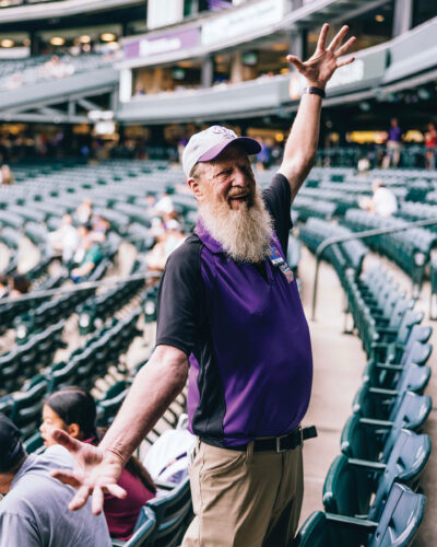 Usher, Bruce Key, poses in the stands at Coors Field.