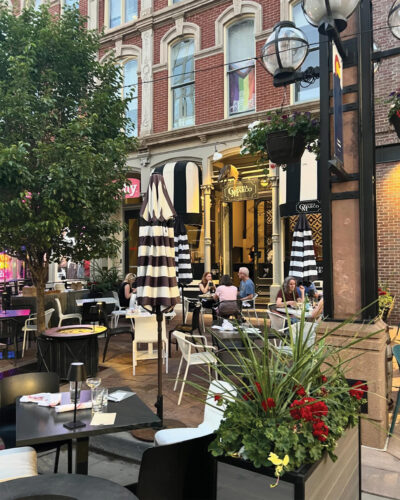 Patio with black and white striped umbrellas at Osteria Marco.