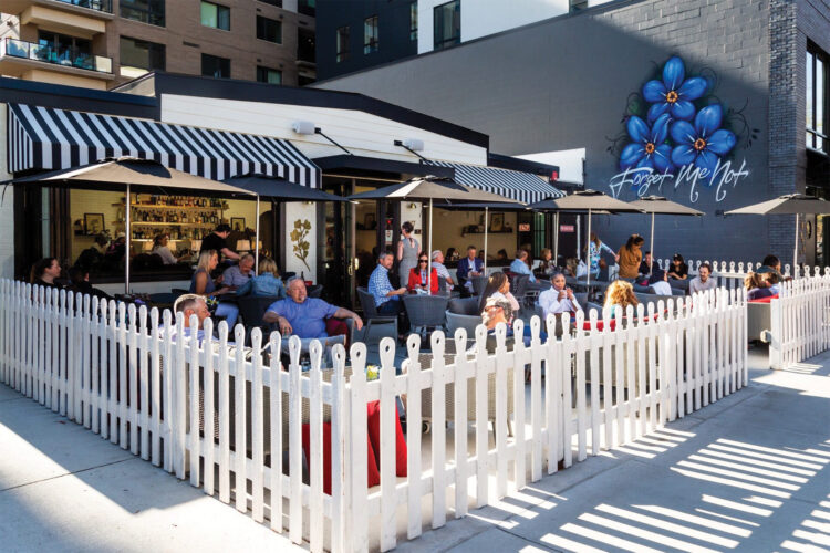 Patio surrounded by white picket fence at Forget Me Not.