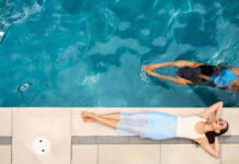 Cocktails, Ice Cream, and the Art of Summer Hosting in Denver Woman swims in pool while another lounges on the side.