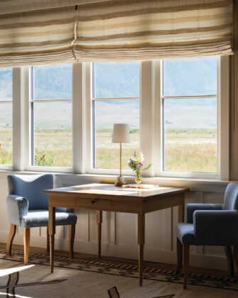 Seating area by large window wall in the Crested Butte home designed by Emily Tucker.