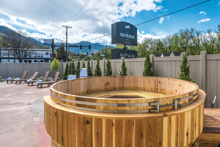 Exterior pool area with barrel hot tub at The Outrider Hotel.