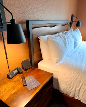 Bed with reading lights at The Outrider Hotel.