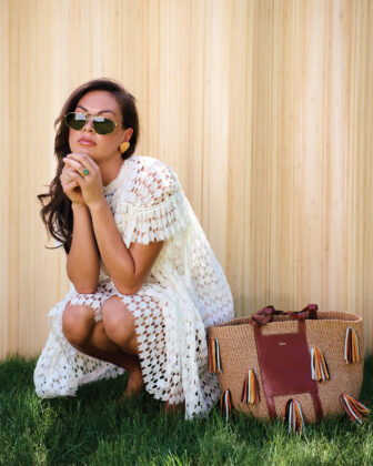 Women couches in backyard in front of bamboo fence.