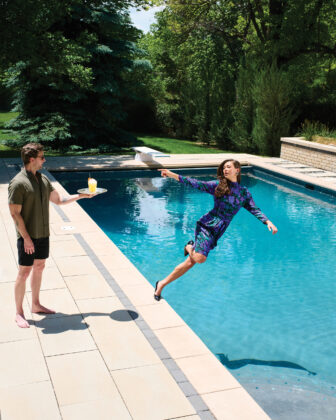 Woman falls into pool while reaching for a cocktail.