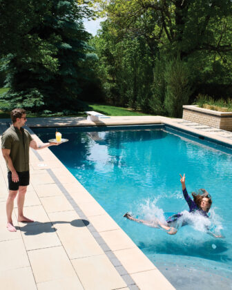 Woman falls into pool while reaching for a cocktail.