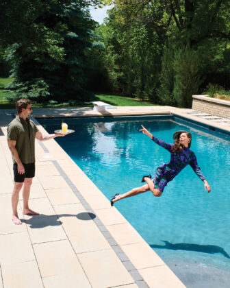 Woman falls into pool while reaching for a cocktail.
