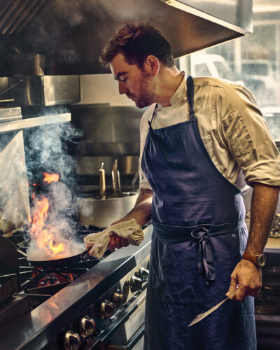 Chef cooks over stove from the 2026 Colorado Chefs feature.