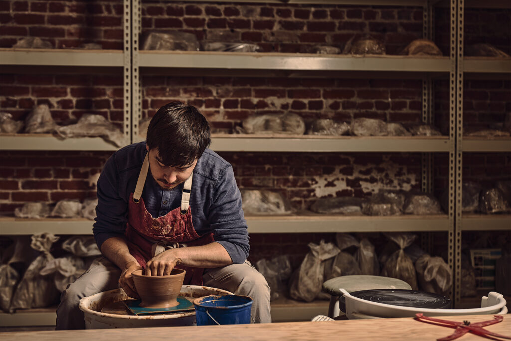 Young man turns pottery bowls on the wheel in the 2026 Colorado Chefs feature.