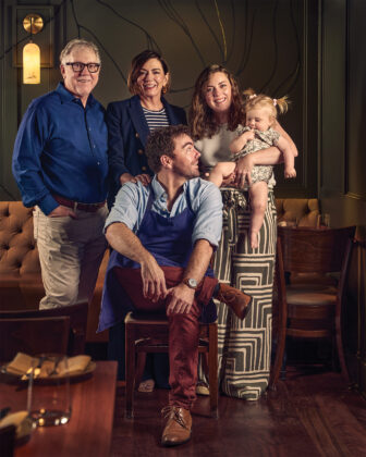 A chef poses with his family and baby in the 2026 Colorado Chefs feature.