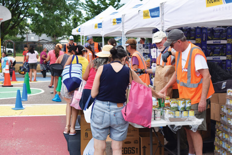 People grab meals from We Don't Waste stand.