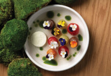 Dish of spheres each garnished with an edible flower at chef Kelly Whitaker's SHEEP.