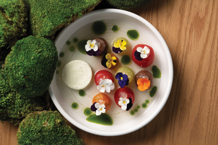 Dish of spheres each garnished with an edible flower at chef Kelly Whitaker's SHEEP.