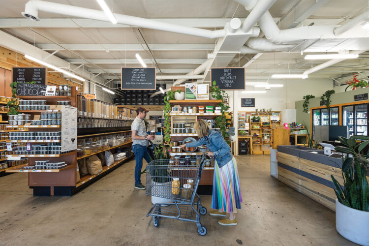 Customers explore products at at Nude Foods Market.