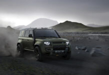Land Rover Unleashes Its Wildest Defender Yet The 2026 Defender 110 OCTA drives through rocky terrain.
