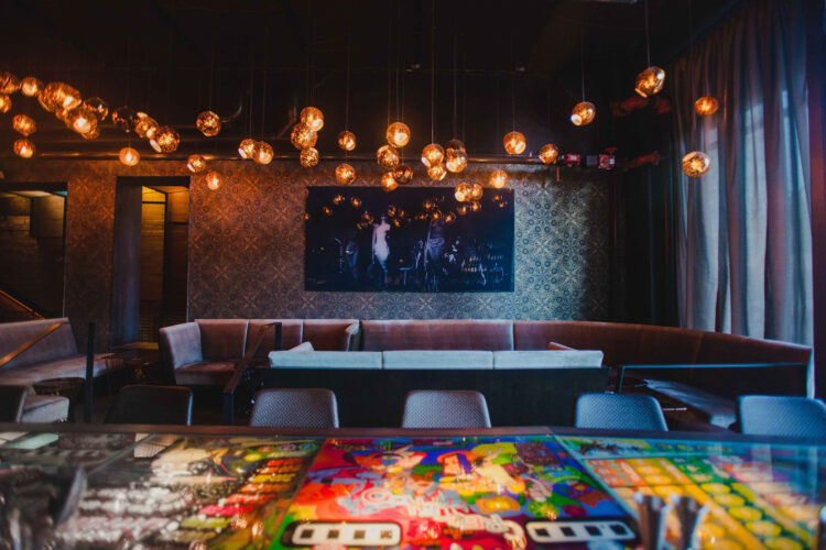 Lounge seating beneath golden pendant lights at Ophelia’s Electric Soapbox.