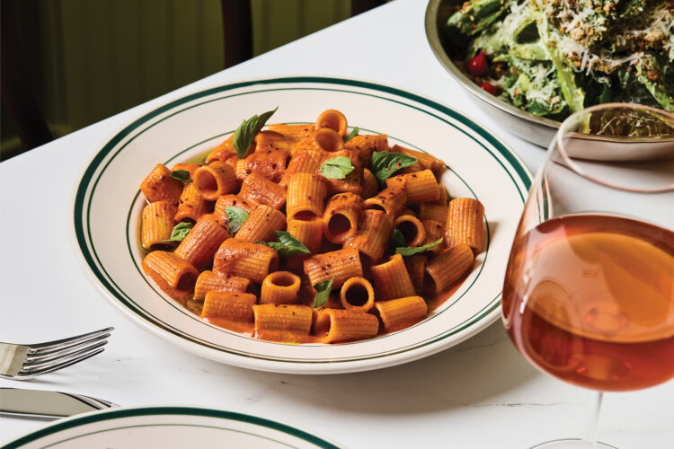 Rigatoni coated in red sauce and garnished with fresh basil at Mother Other.
