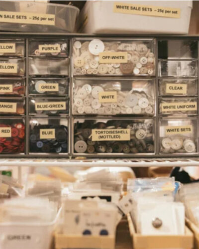 Buttons sorted by color into labeled drawers at ReCreative Denver.